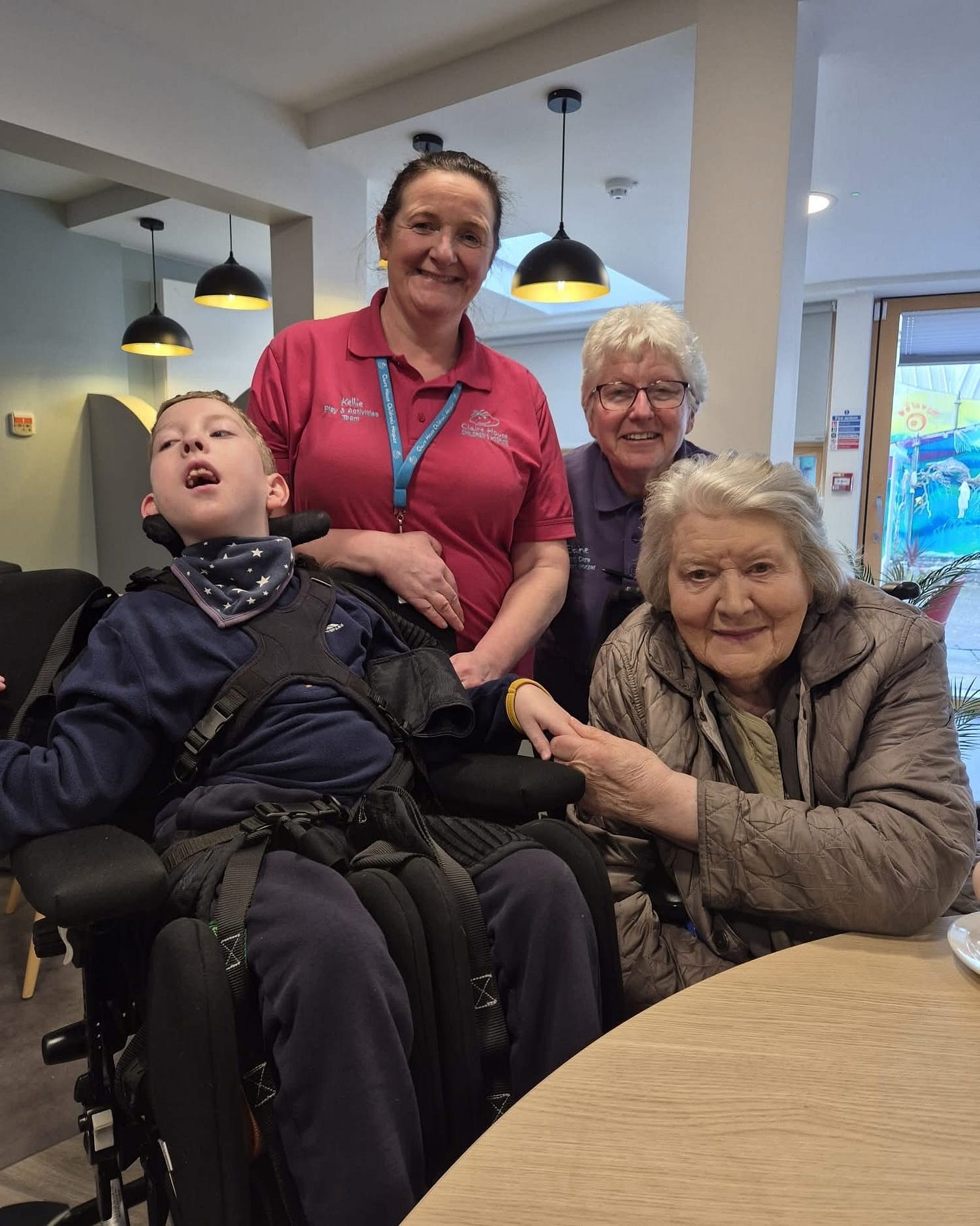 May be an image of 3 people, people smiling and hospital