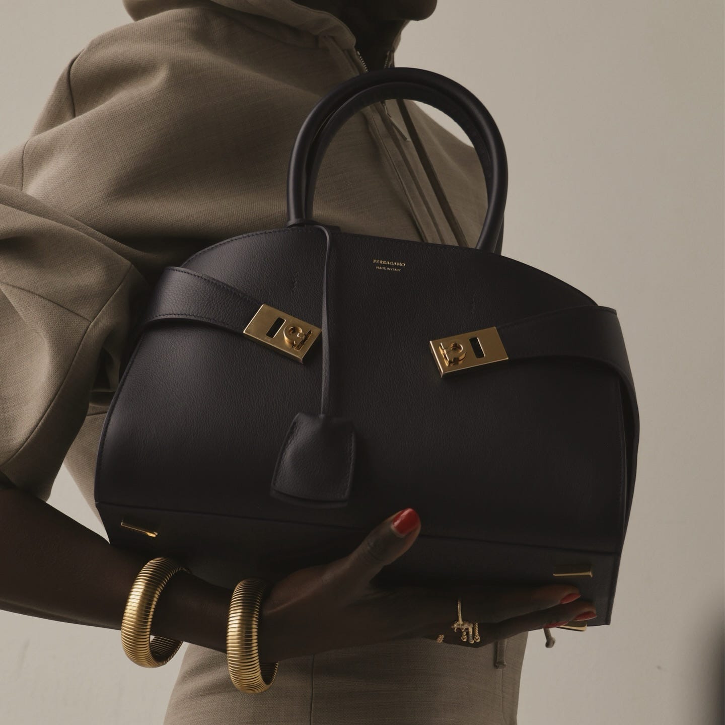 Woman carries Ferragamo Hug bag