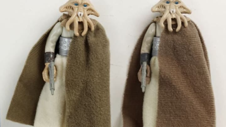 Two Star Wars action figures of Tessek the Quarren with his brown robe and blaster. His face has squid-like pincers and tentacles. Two Star Wars action figures of Tessek the Quarren with his brown robe and blaster. His face has squid-like pincers and tentacles.