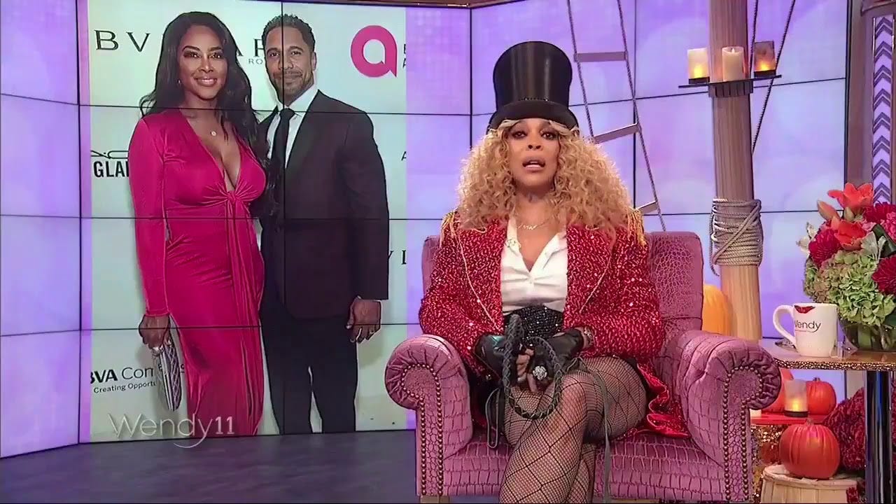 Wendy Williams sitting in a chair on set of her talkshow dressed as a circus ring leader.
