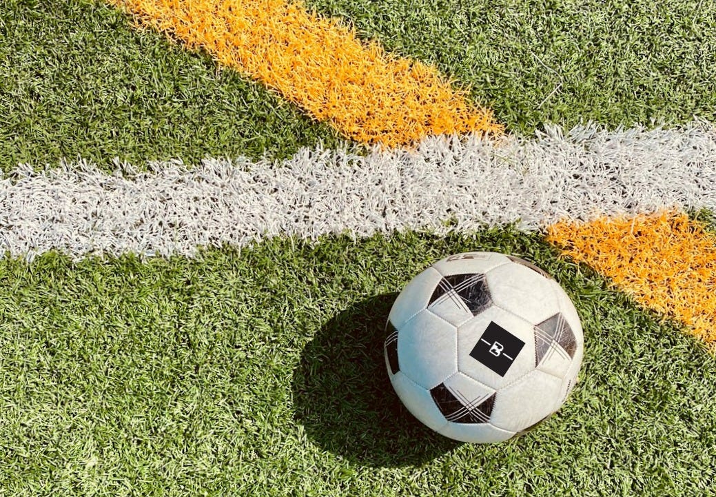 white and black soccer ball on green grass field white and black soccer ball on green grass field