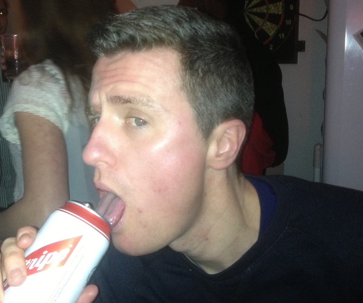 Me at a party in 2013, for some reason tonguing the opening of a can of Red Stripe