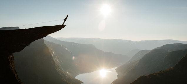A person standing on a rock

AI-generated content may be incorrect.