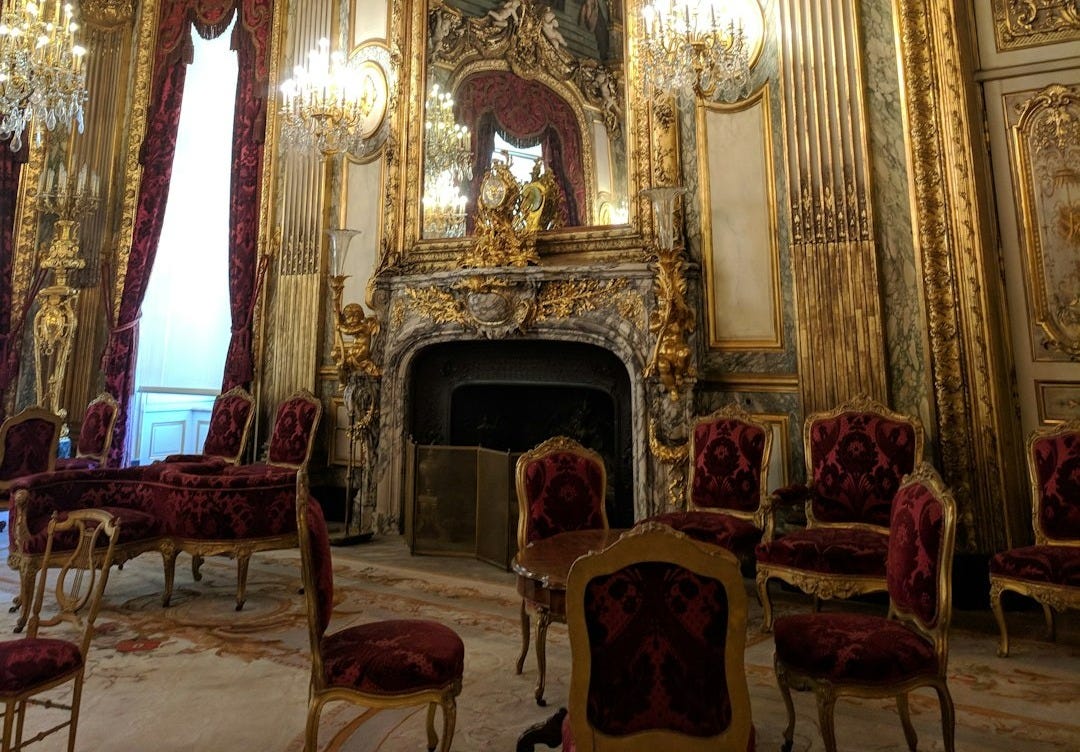 people sitting on red chairs inside building