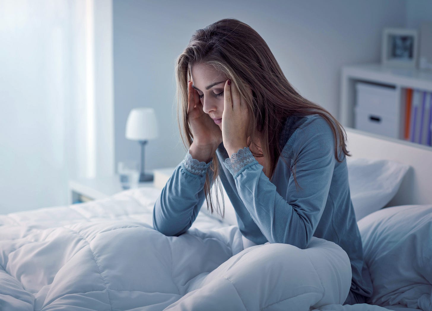 Femme assise dans son lit se réveillant