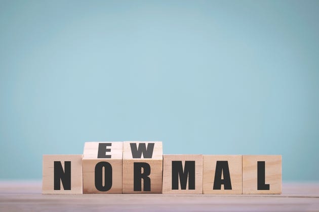 Wooden block cubes flipping for new normal word to changing new lifestyle or business and economy after coronavirus pandemic
