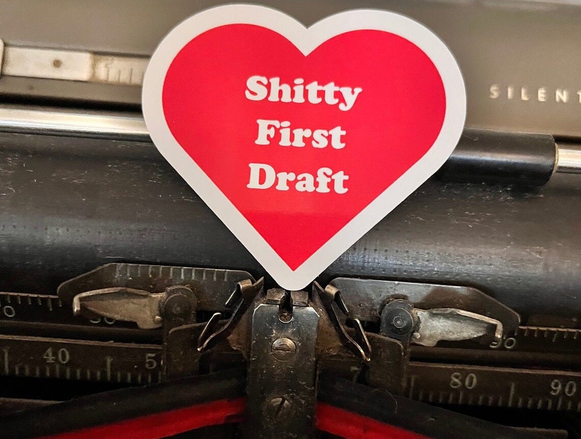 May include: A red heart-shaped sticker with white text that reads 'Shitty First Draft'.