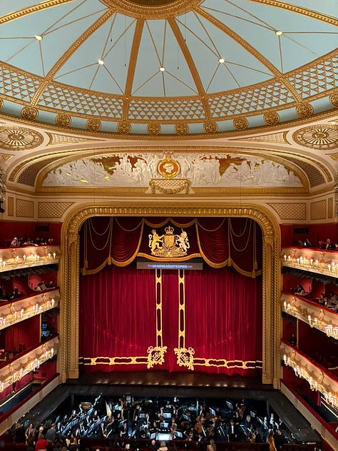 two women in front of the O2 arena; a woman in front of Keats House in Hampstead, two women in front of the Royal Opera House in London; the inside of the Royal Opera House in London; tower bridge at night; a picnic in the park