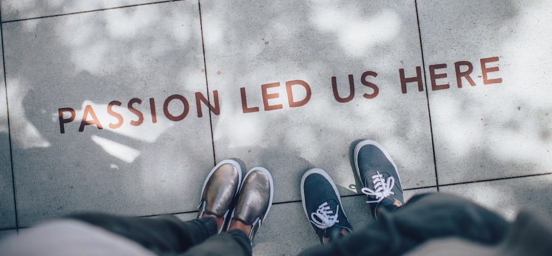 two person standing on gray tile paving two person standing on gray tile paving