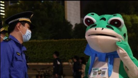 Street seller in frog costume being confronted by Chinese police Street seller in frog costume being confronted by Chinese police