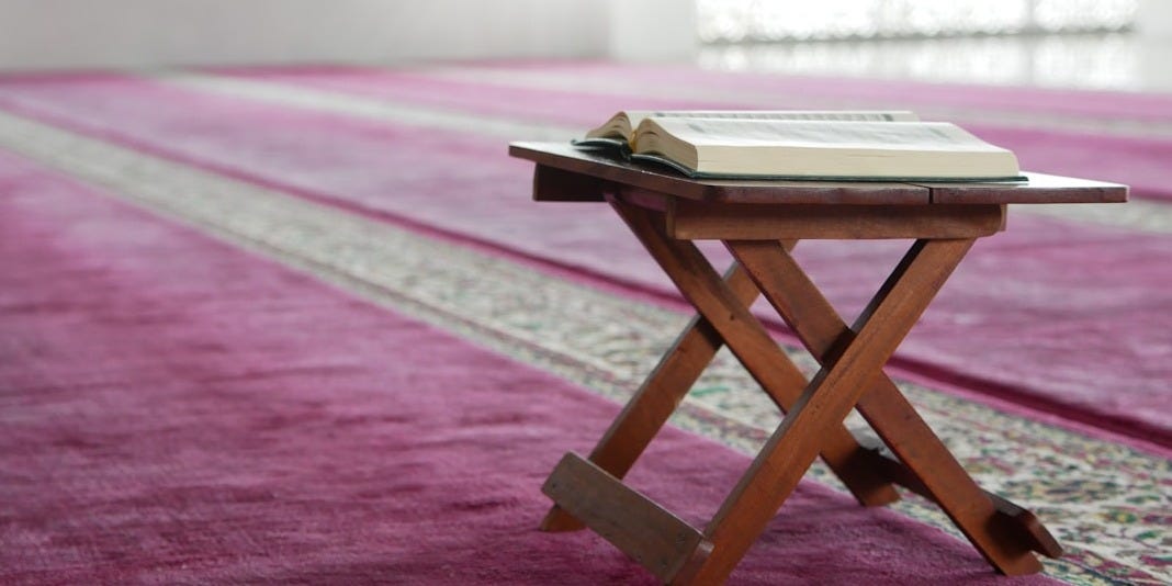 a small wooden table with a book on top of it