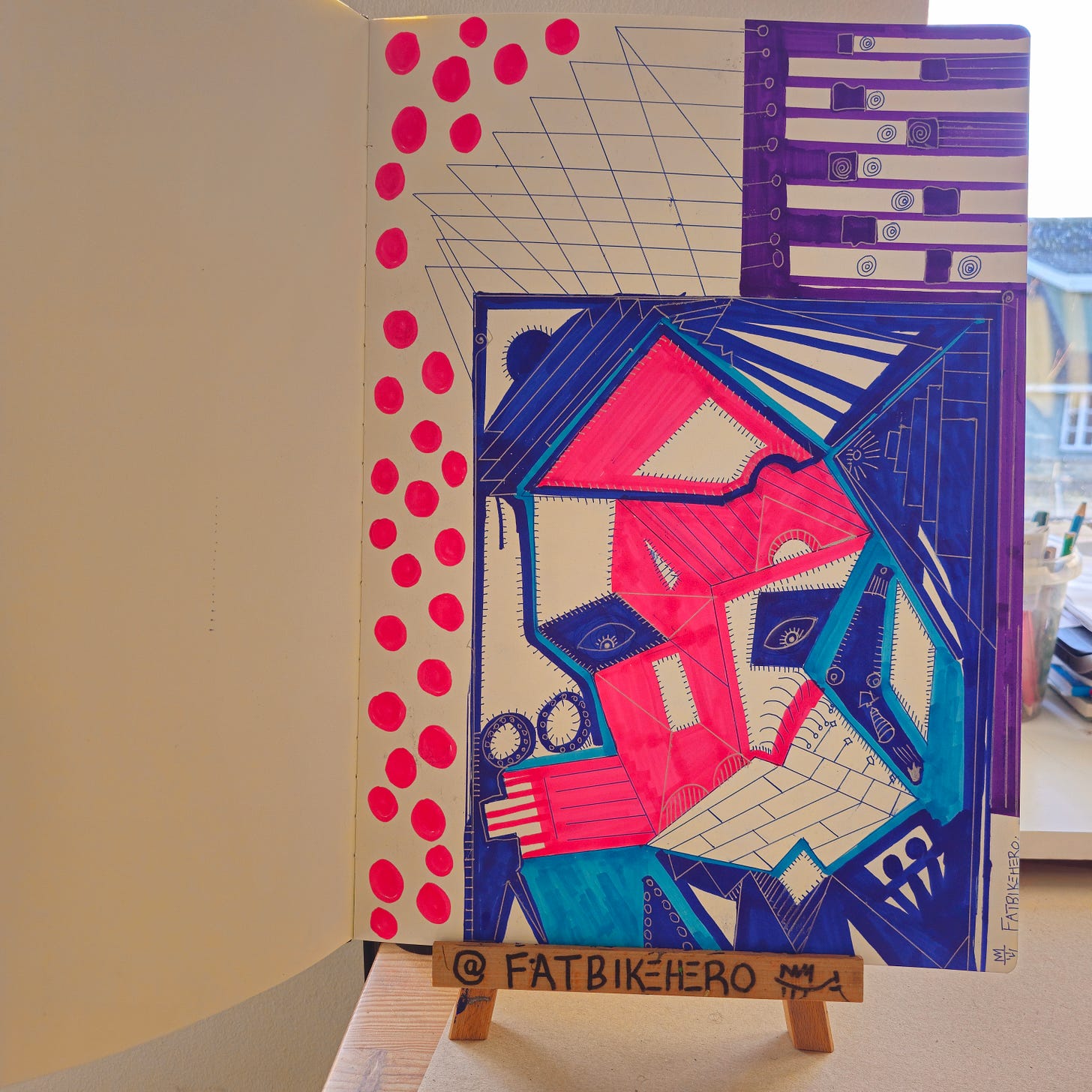 Alt Text: A sketchbook page by FatbikeHero featuring a geometric, cubist-style portrait in neon pink, blue, and purple markers. The composition includes grid lines, spirals, and a column of pink dots.