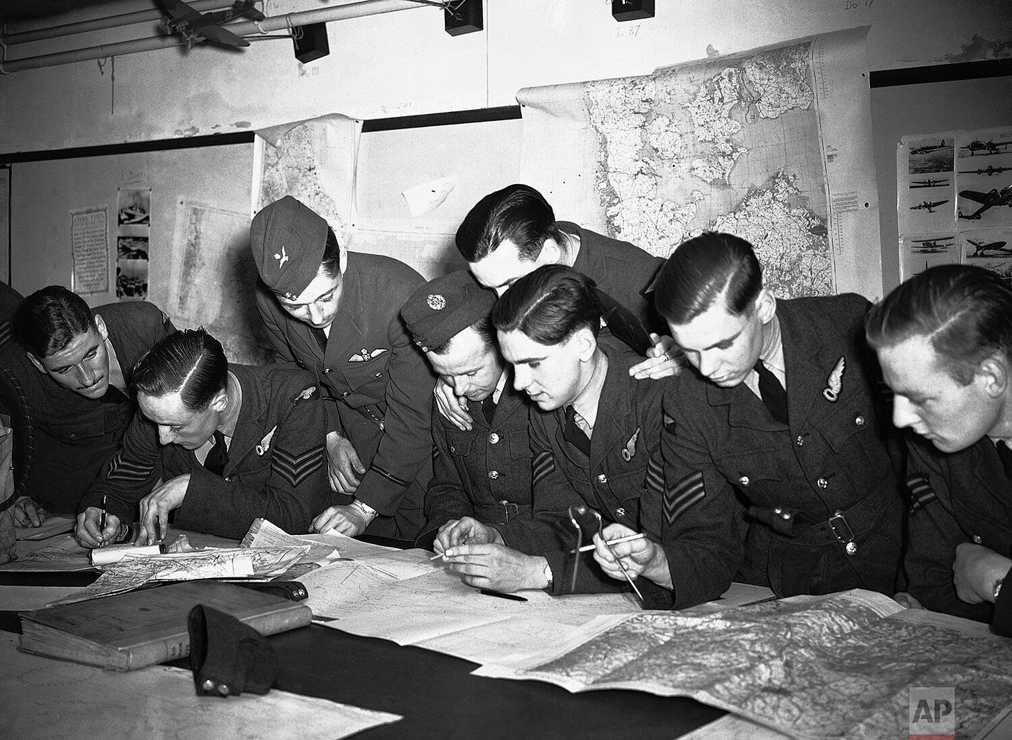 RAF bomber crews receive their final briefing from their navigation officer in England on September 5, 1940, preparing for a mission to bomb military targets in Germany.