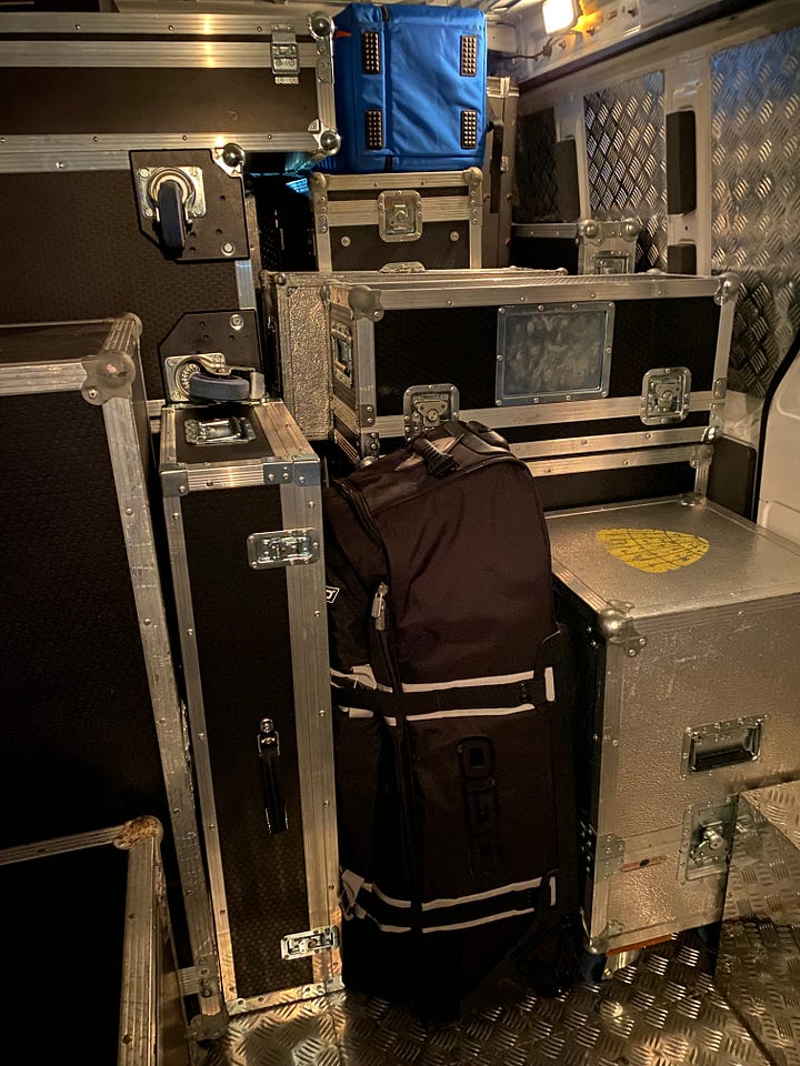 Flight cases and bottles of wine in the back of the Van of Rock