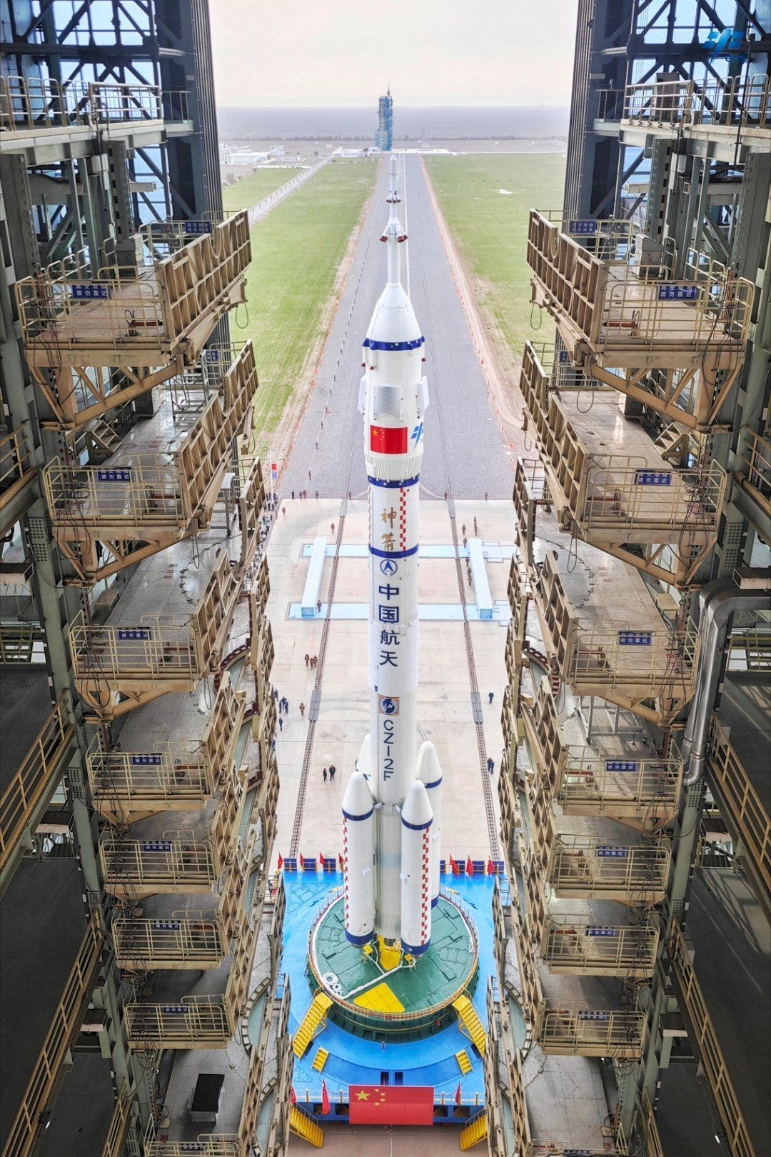 The Long March 2F/G Y21 vehicle as seen from its vehicle assembly building during rollout to its launch pad on October 24th 2025. The Long March 2F/G Y21 vehicle as seen from its vehicle assembly building during rollout to its launch pad on October 24th 2025.