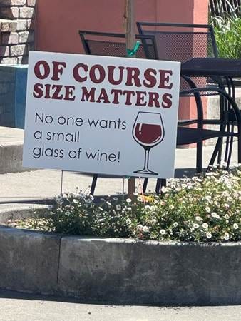 A sign in a flower bed

AI-generated content may be incorrect.