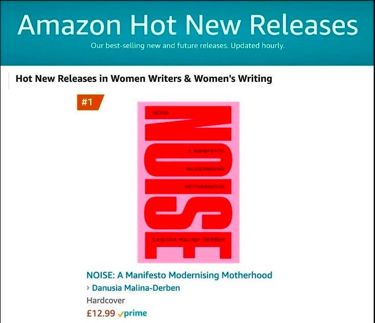 Screenshot of the Amazon Hot New Releases chart showing NOISE: A Manifesto Modernising Motherhood by Danusia Malina-Derben ranked #1 in the category "Women Writers & Women's Writing." The book cover is bright pink and red with bold typography.