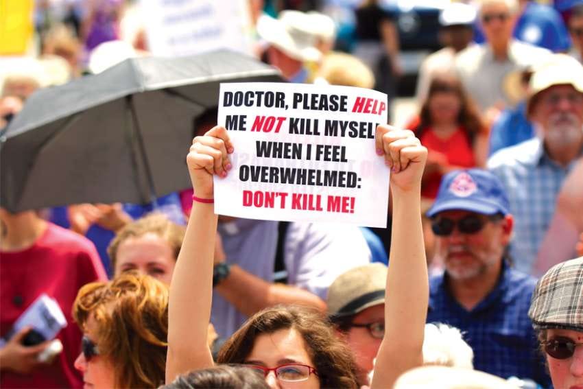 Sign sends a message at rally against assisted suicide.