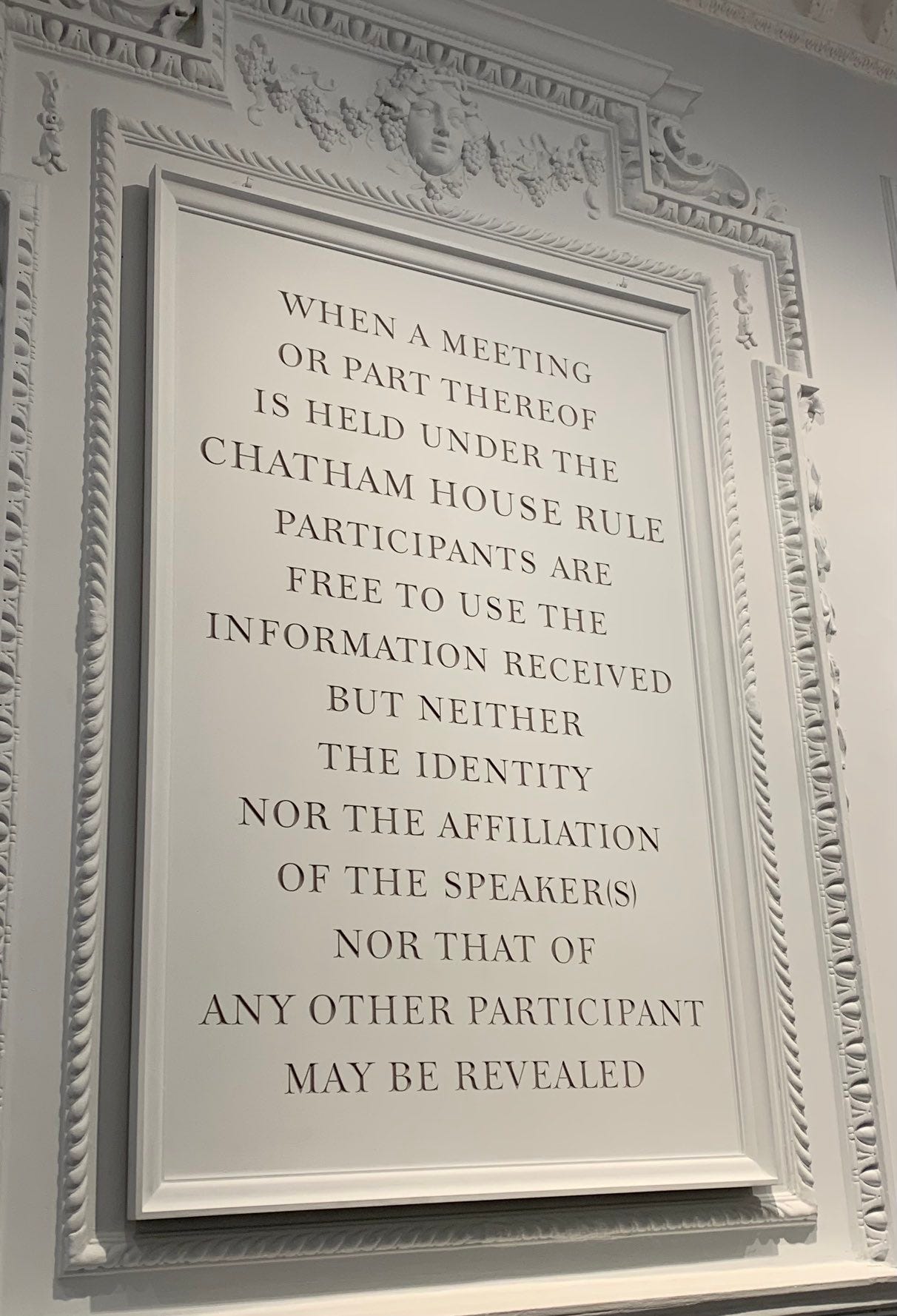 An inscription in white stone reads ‘When a meeting or part thereof is held under the Chatham house Rule participants are free to use the information received, but neither the identity nor the affiliation of the speaker(s), nor that of any other participant, may be revealed.’