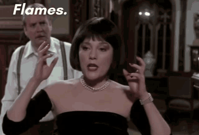 an angry Madeline Kahn tries to describe how angry she is, gesturing to her face. The caption reads "Flames. Flames. Flames. On the side of my face."