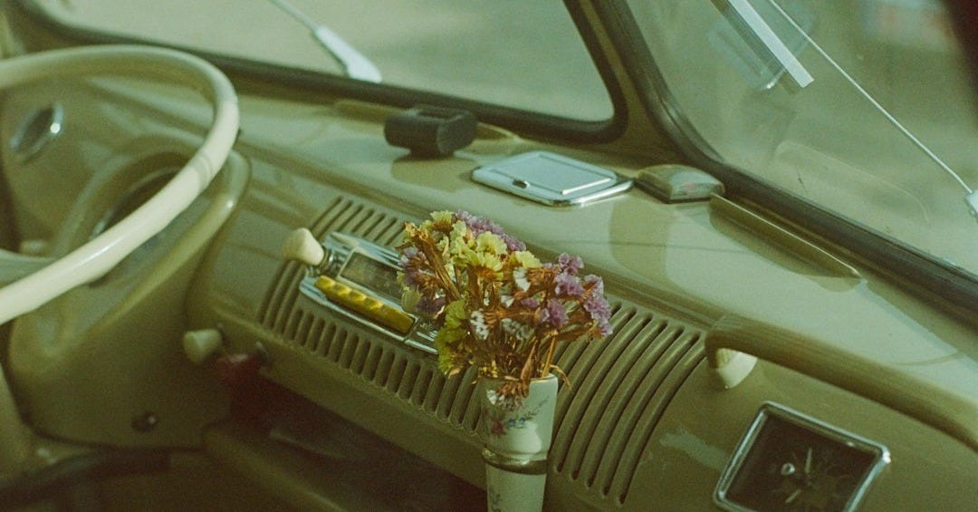 The interior of a car with a steering wheel and dashboard