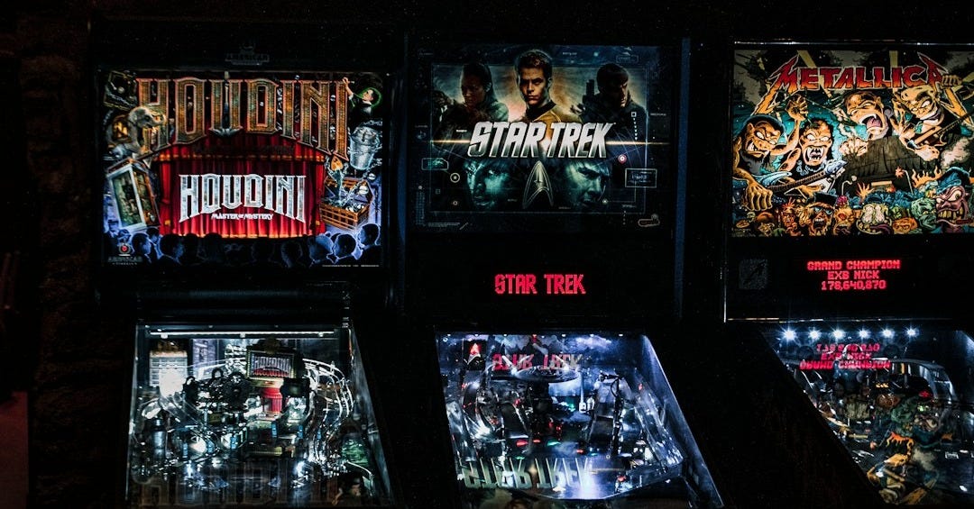 a row of pinball machines sitting next to each other