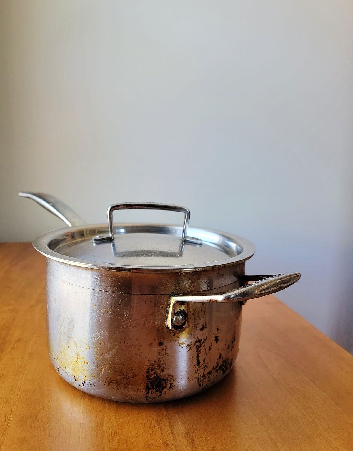 A well-loved cooking pot on a table. 