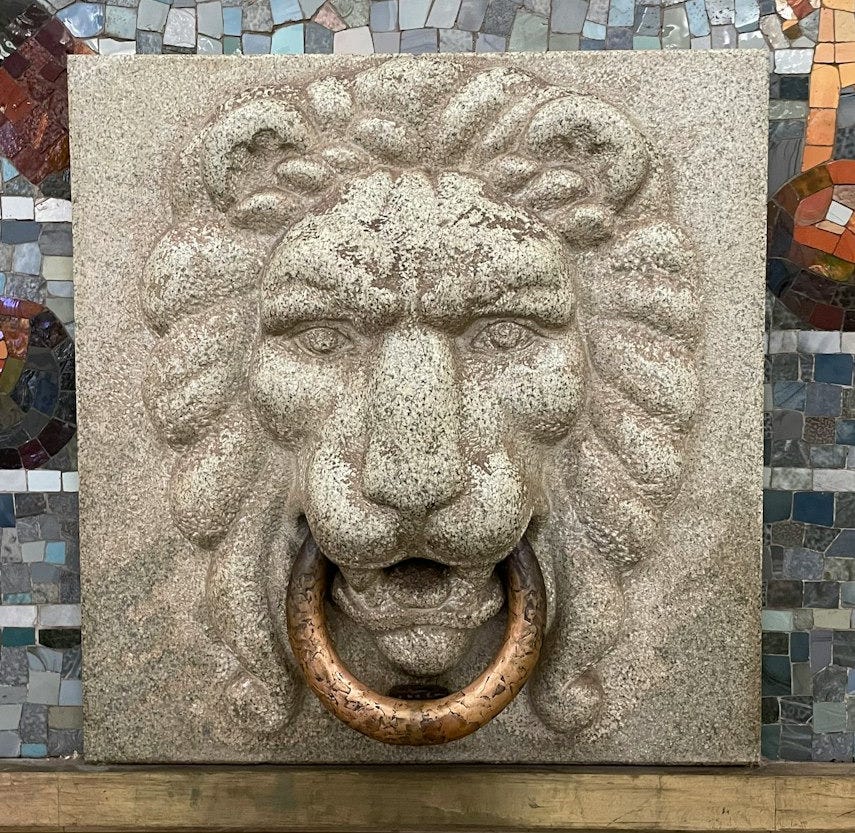 a lion's head on a wall with mosaic tiles a lion's head on a wall with mosaic tiles