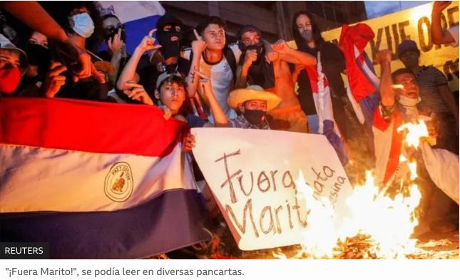 A group of people holding signs

Description automatically generated