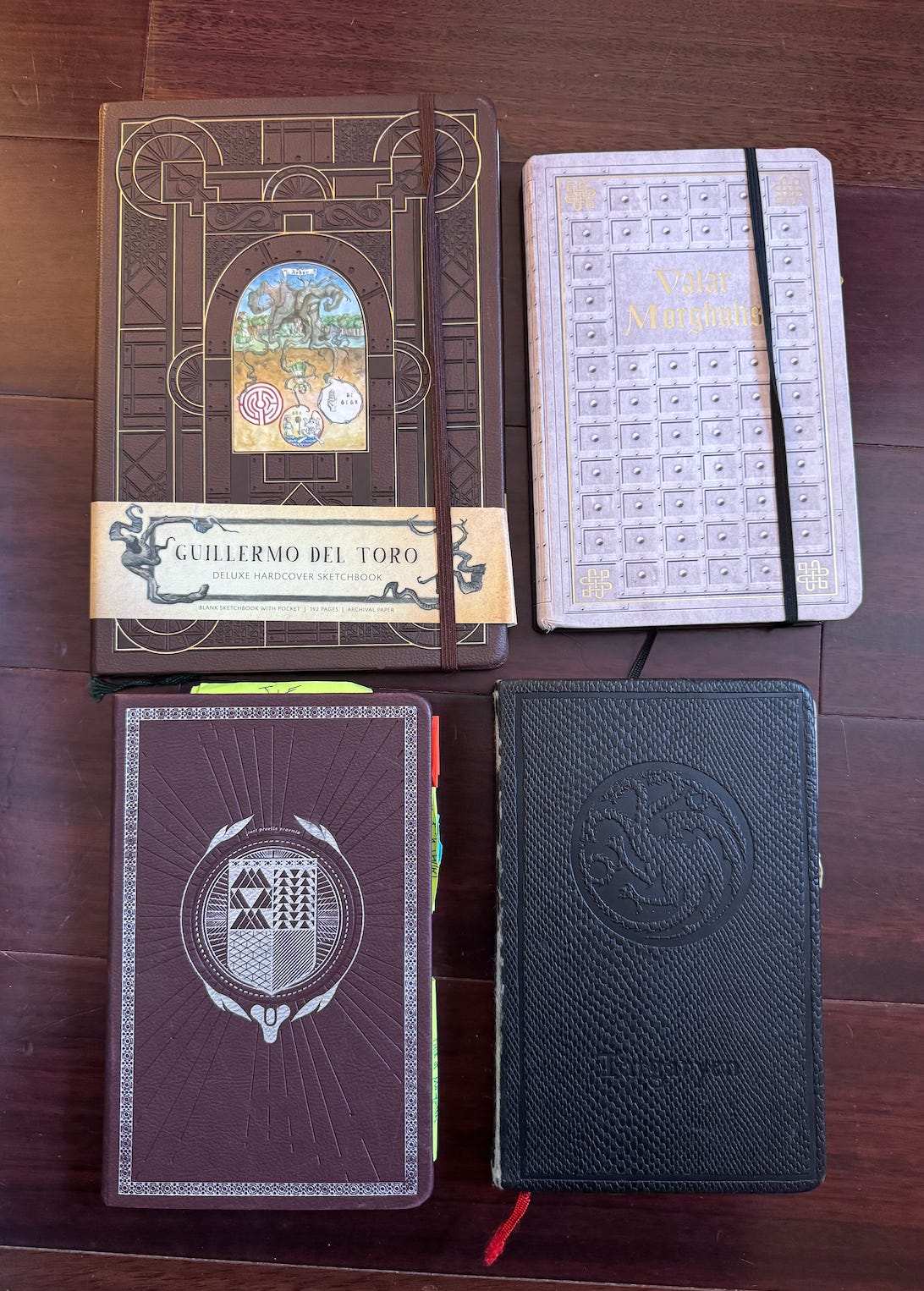 A photo of Kat’s Insight Editions journals. This picture includes a Guillermo del Toro journal, two Game of Thrones themed journals, and a Destiny themed journal.
