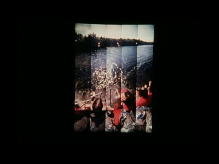 a 5x5 grid composed of shots of the same landscape, a view with two figures sitting upon rocks by the lakeside