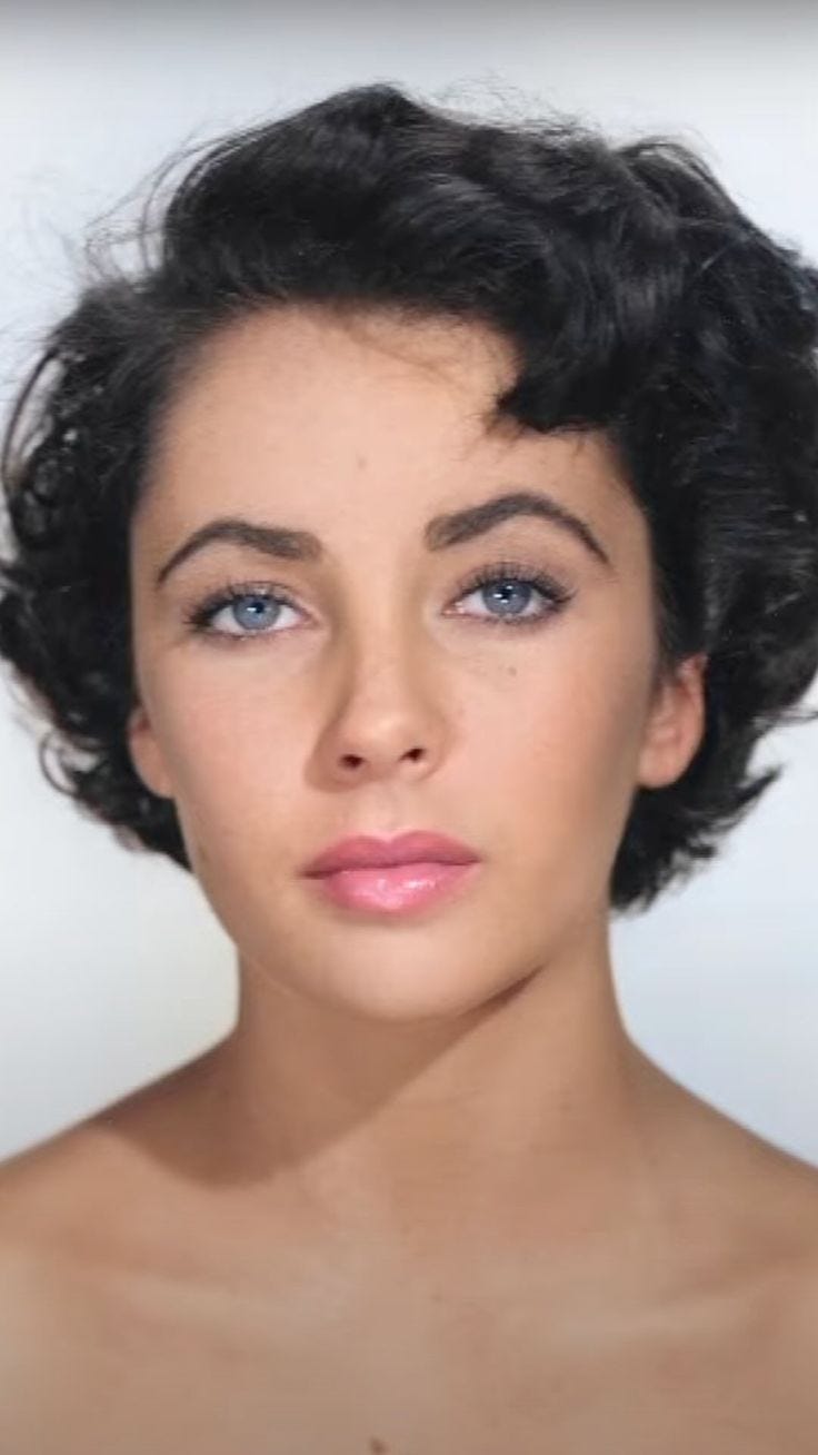 This may contain: a woman with short black hair and blue eyes