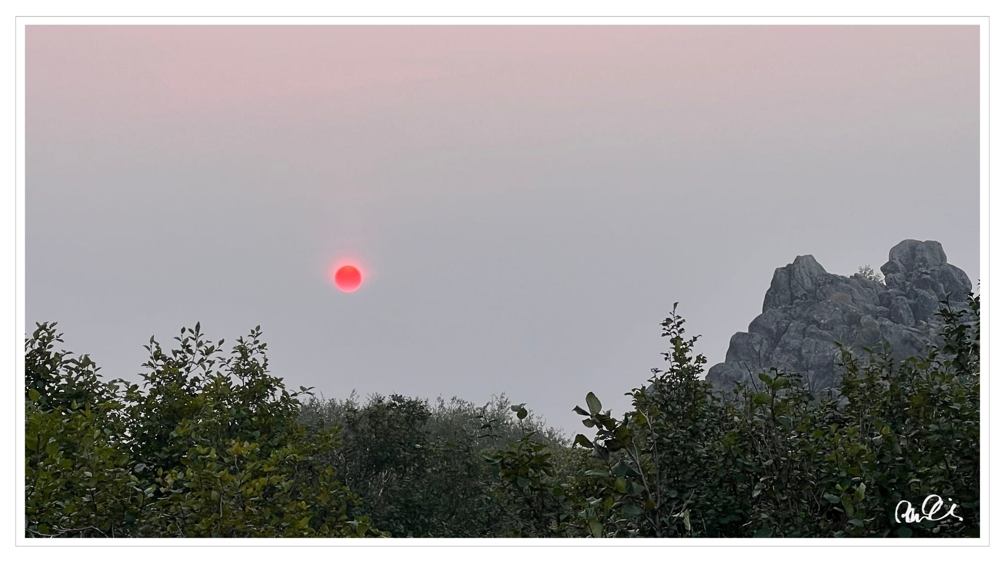 Setting sun through dense wildfire smoke just south of Arctic Circle, Alaska