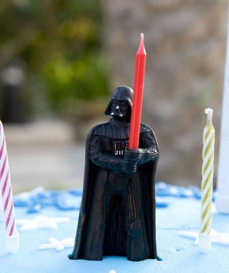 This may contain: a darth vader candle holder with two candles