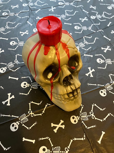 Pumpkins and leaves, skull and candle, yard with tombstones and skeleton