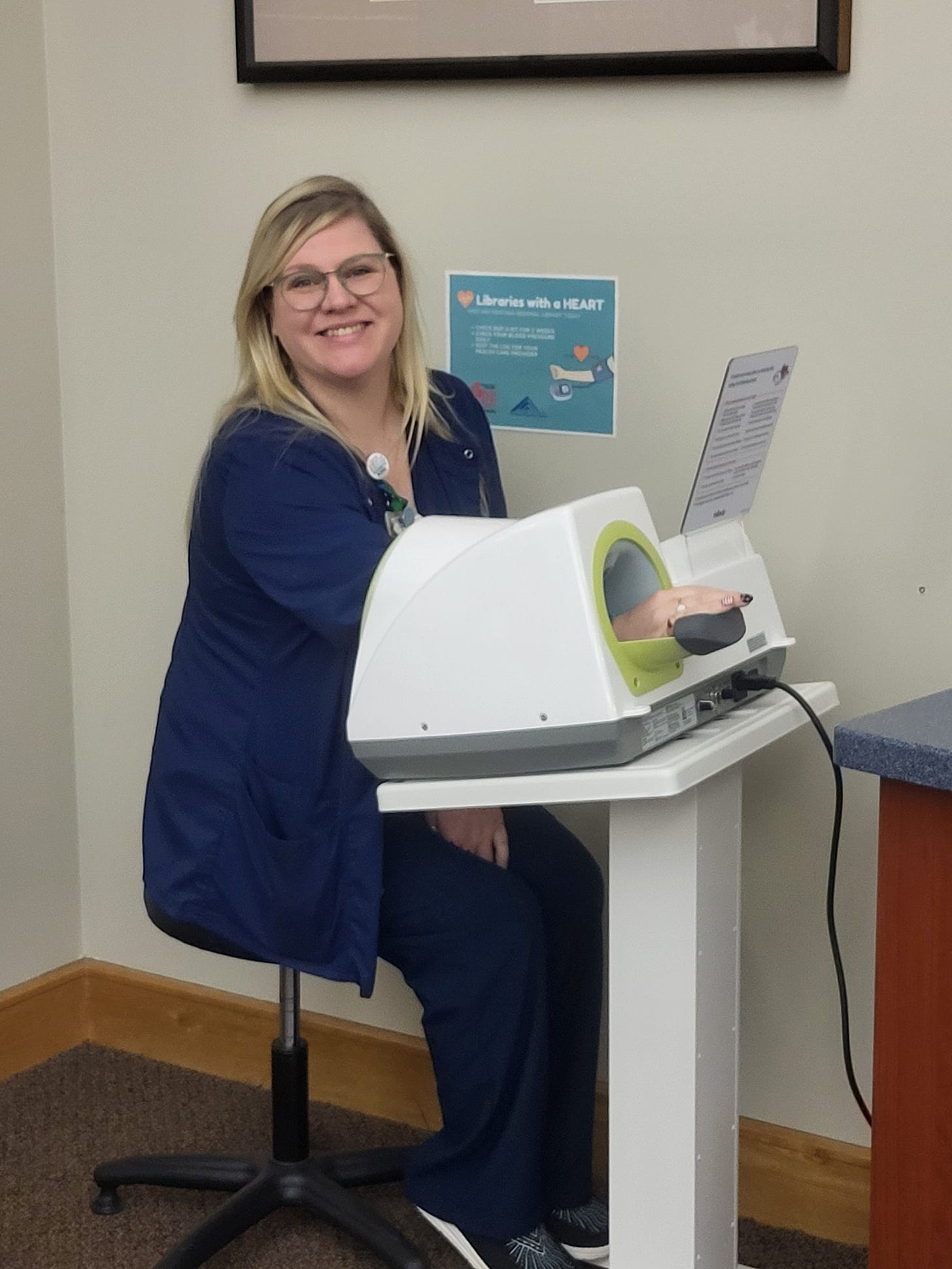 NC libraries patron using Fontana Regional Library's blood pressure machine