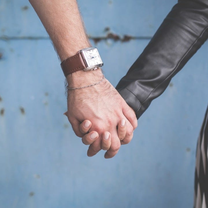 man and woman holding hands