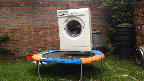 Washing machine bouncing around on a trampoline.
