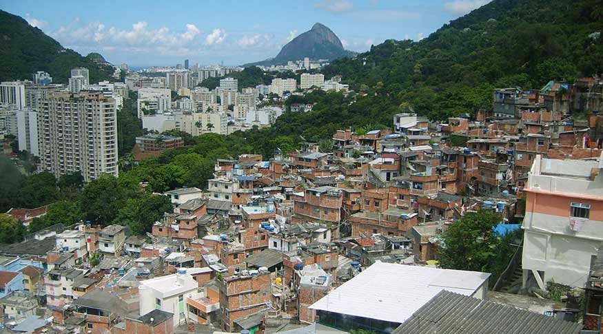 Photo showing a favela in the foreground and expensive apartements in the background with Pao de Acucar in the distant background. Photo showing a favela in the foreground and expensive apartements in the background with Pao de Acucar in the distant background.