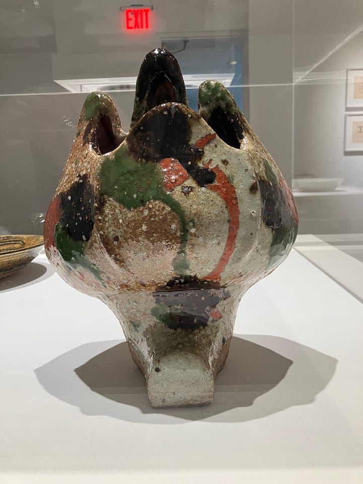 installation photographs of rounded ceramic vessels with multicolored abstract patterns