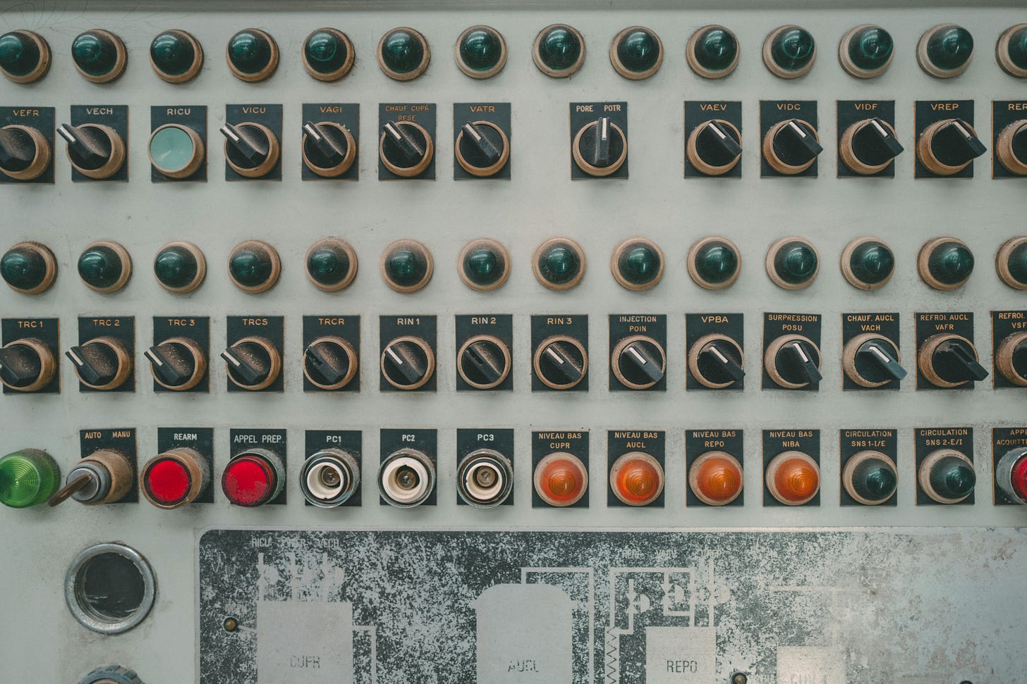A control panel with many toggles to flip
