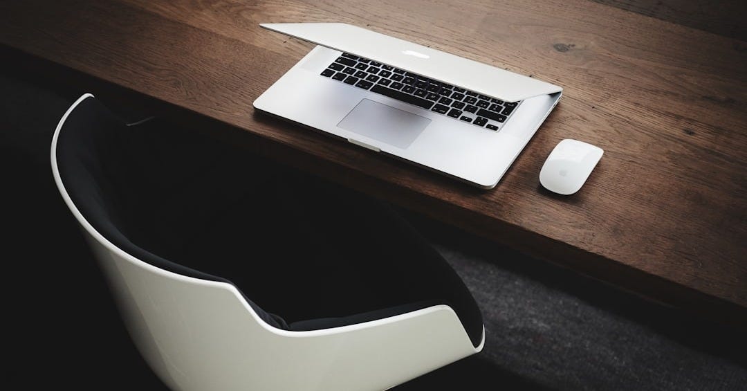 Apple MacBook beside computer mouse on table Apple MacBook beside computer mouse on table