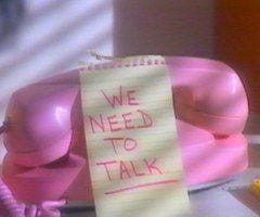 a grainy vintage photo of a pink corded phone with a post-it on it that says WE NEED TO TALK a grainy vintage photo of a pink corded phone with a post-it on it that says WE NEED TO TALK