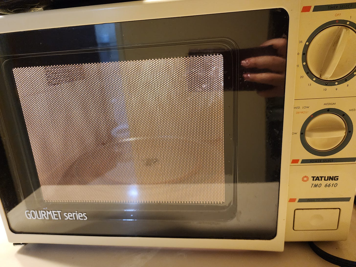 the hilariously ancient microwave, with dials as controls and that made a VERY loud noise when in use the hilariously ancient microwave, with dials as controls and that made a VERY loud noise when in use