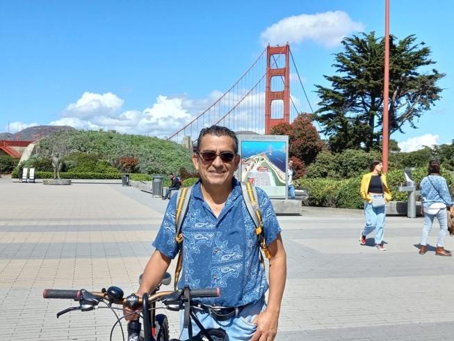 A person standing next to a bicycle

Description automatically generated with low confidence