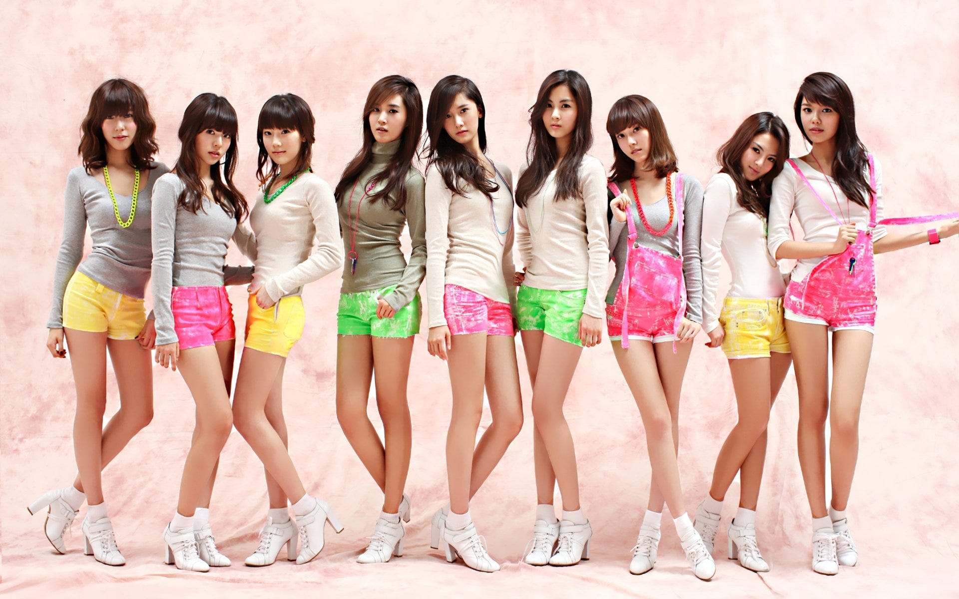 HD desktop wallpaper featuring the members of Girls' Generation (SNSD) posing stylishly, showcasing vibrant shorts and casual tops in a music-themed image.