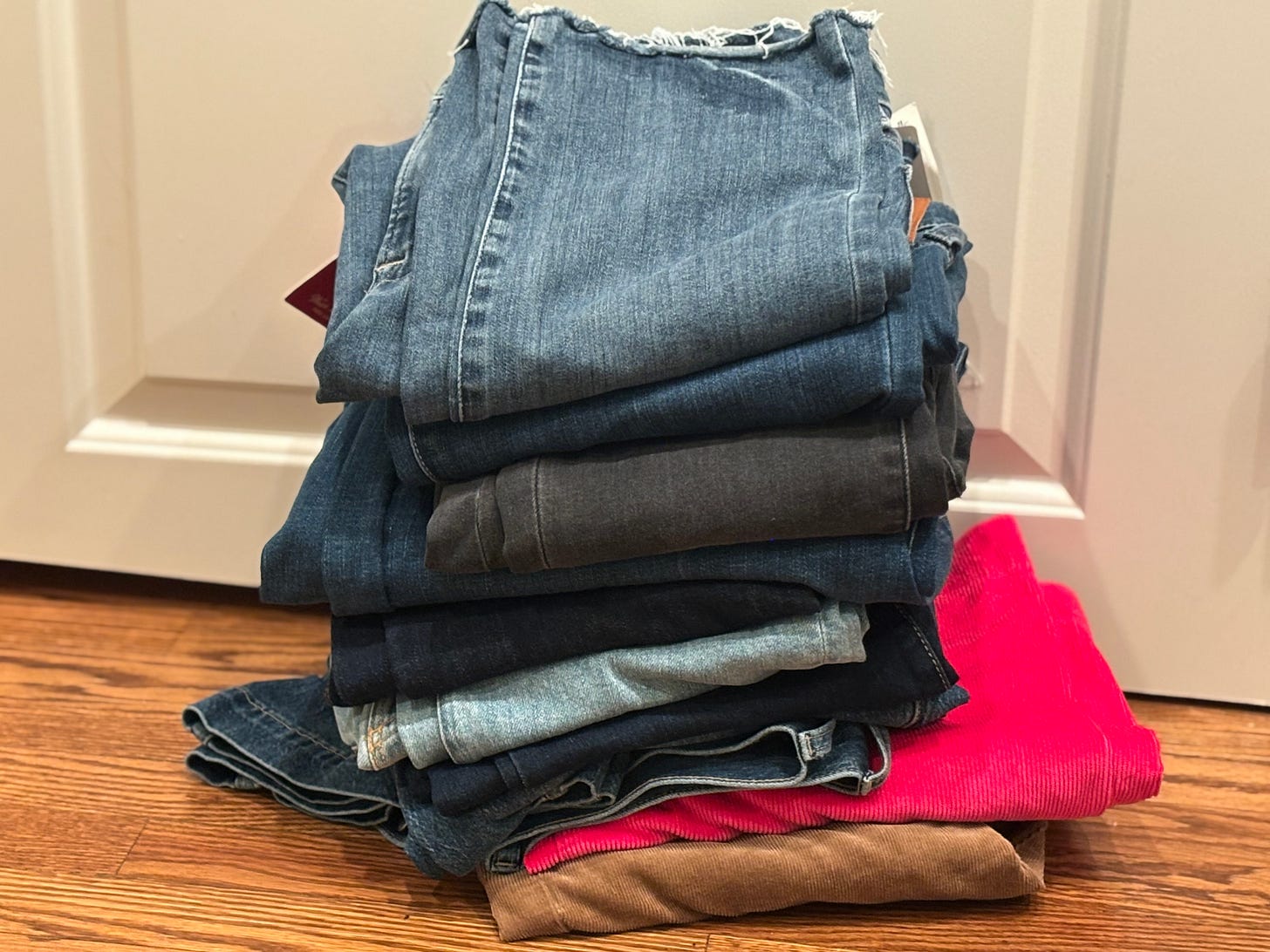 pile of denim and corduroy women's jeans