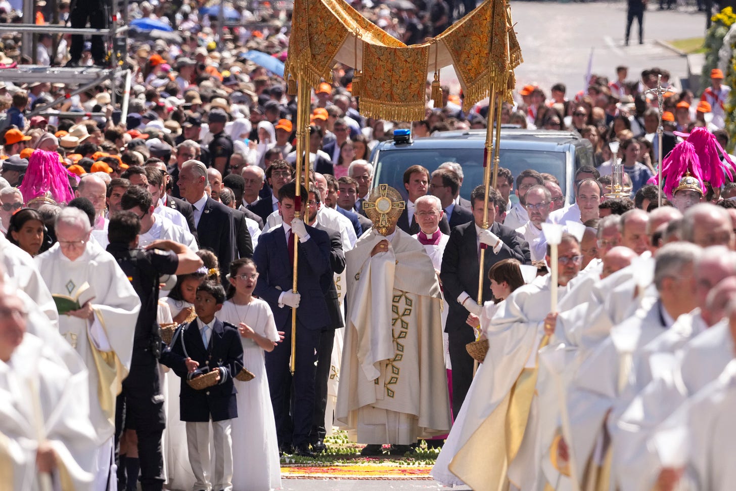 Pope Leo XIV carries the Blessed Sacrament beneath a canopy in Madrid