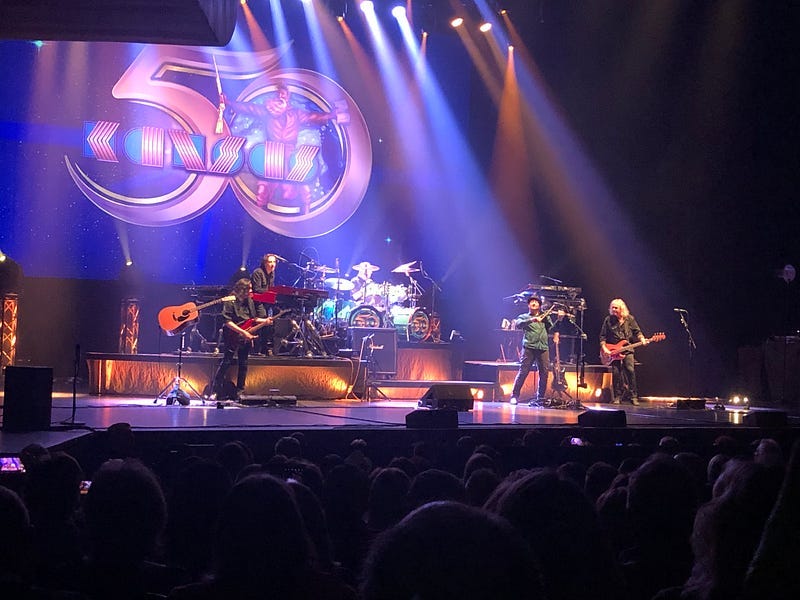 A band onstage with instruments and lighting.