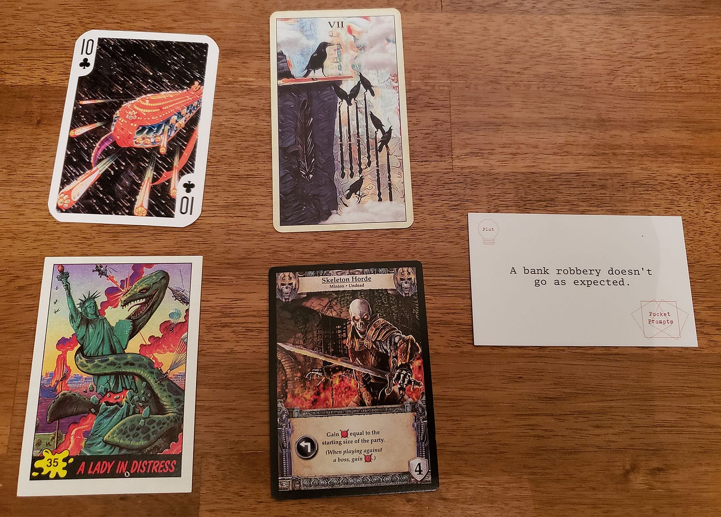 The cards that inspired A Lone Star on the Lady Liberty, with crows, skeletons, a spaceship, and the statue of liberty.